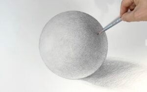 Hand drawing a shaded white sphere using pencil and cross-hatching technique